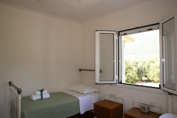 Hidden Gem Kefalonia (House Rental) a bedroom with a bed and a window 2