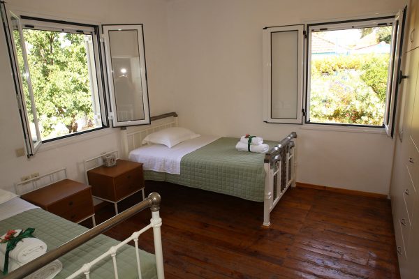 Hidden Gem Kefalonia (House Rental) a bedroom with two beds and a window