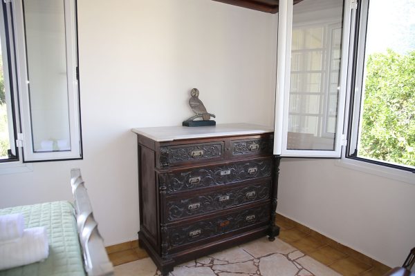 Hidden Gem Kefalonia (House Rental) a dresser with a bird on top of it
