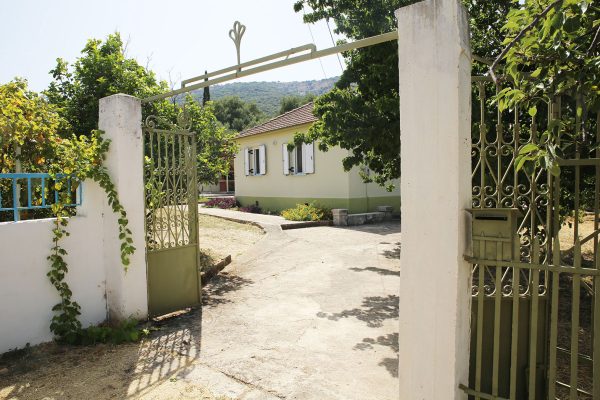 Hidden Gem Kefalonia (House Rental) a gated entrance to a house with a blue gate