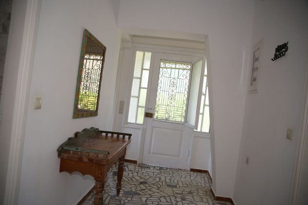 Hidden Gem Kefalonia (House Rental) a hallway with a door and a table