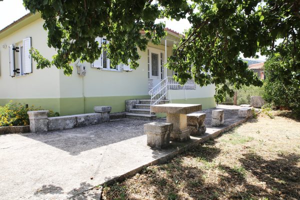 Hidden Gem Kefalonia (House Rental) a house with a picnic table under a tree