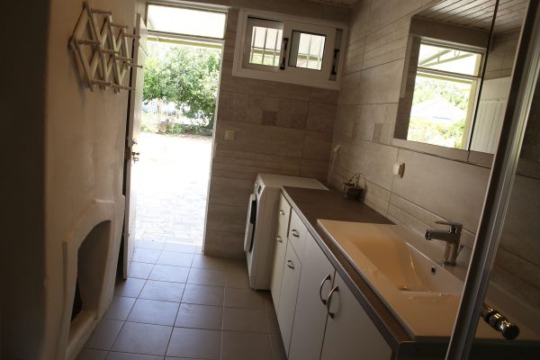 Hidden Gem Kefalonia (House Rental) a kitchen with a sink and a window