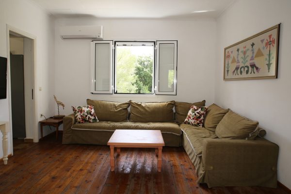 Hidden Gem Kefalonia (House Rental) a living room with a couch and a coffee table