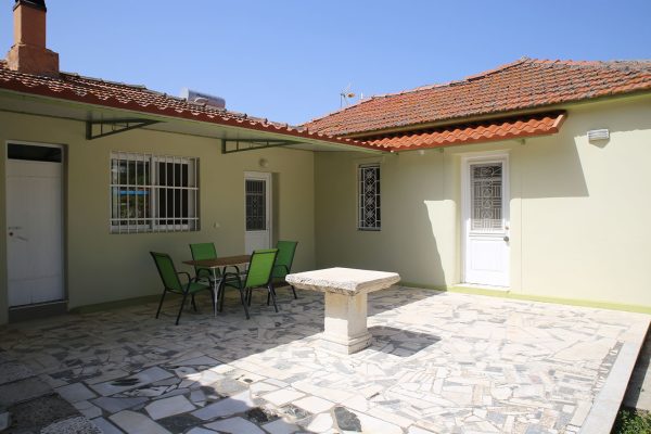 Hidden Gem Kefalonia (House Rental) a patio with a table and chairs